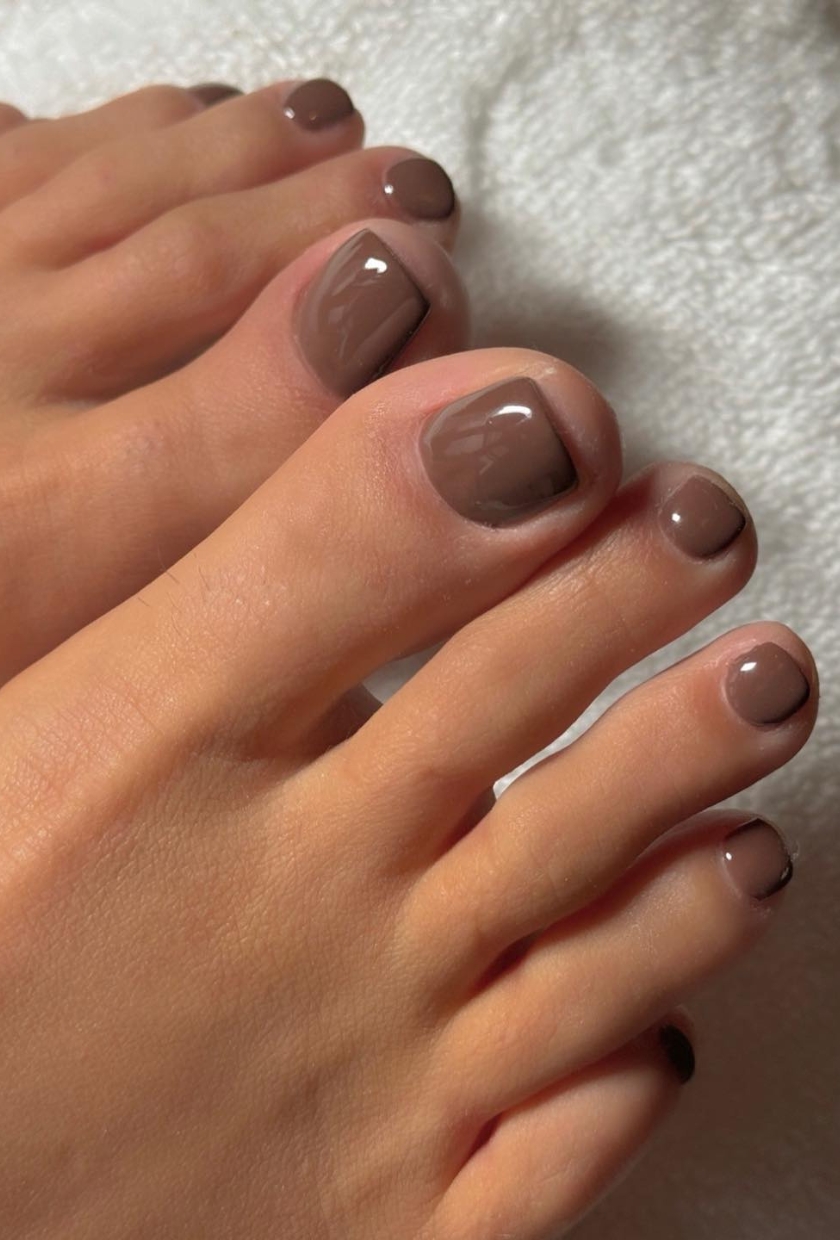 A close up shot of a light brown pedicure