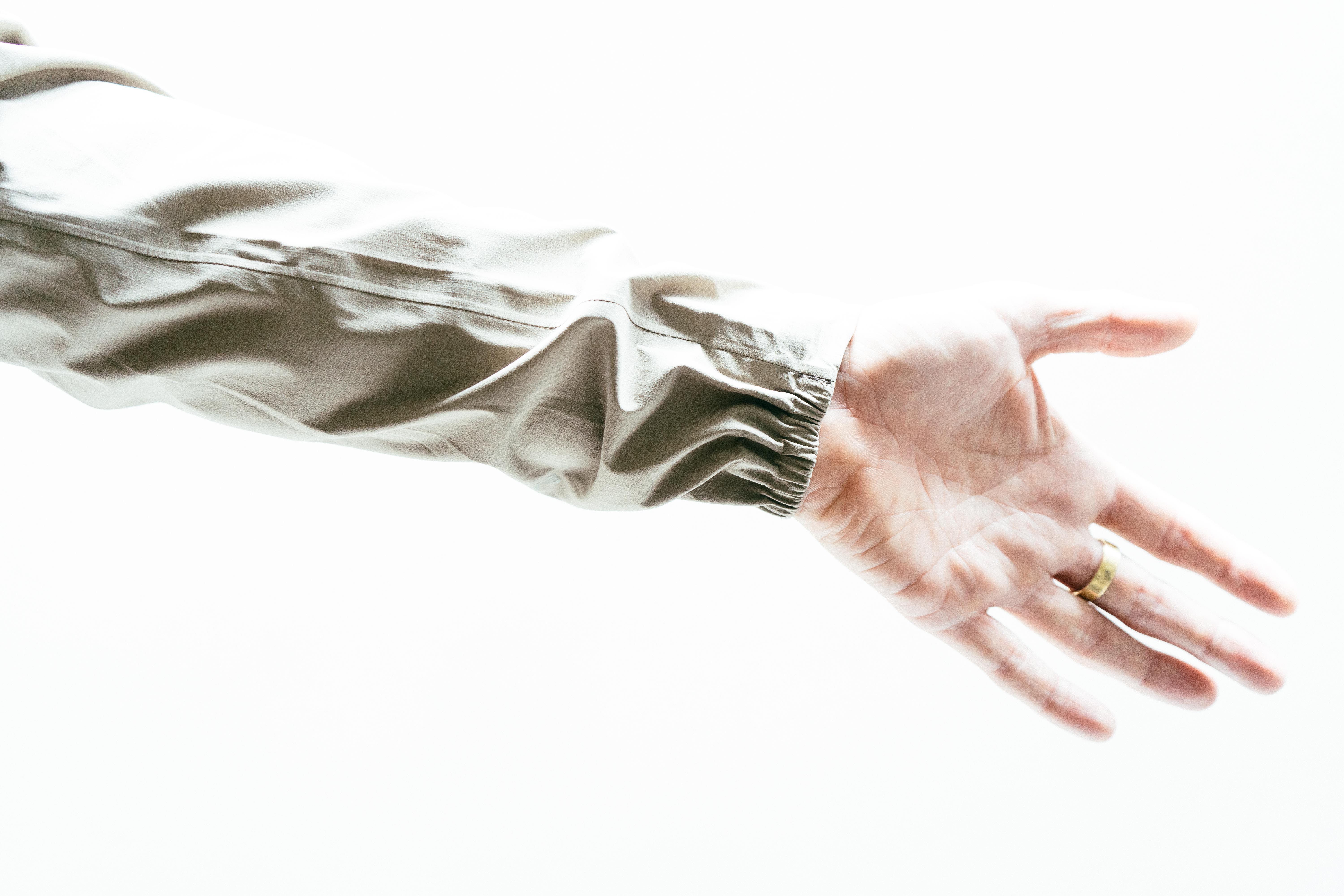 The cuffs of an off-white waterproof cycling jacket