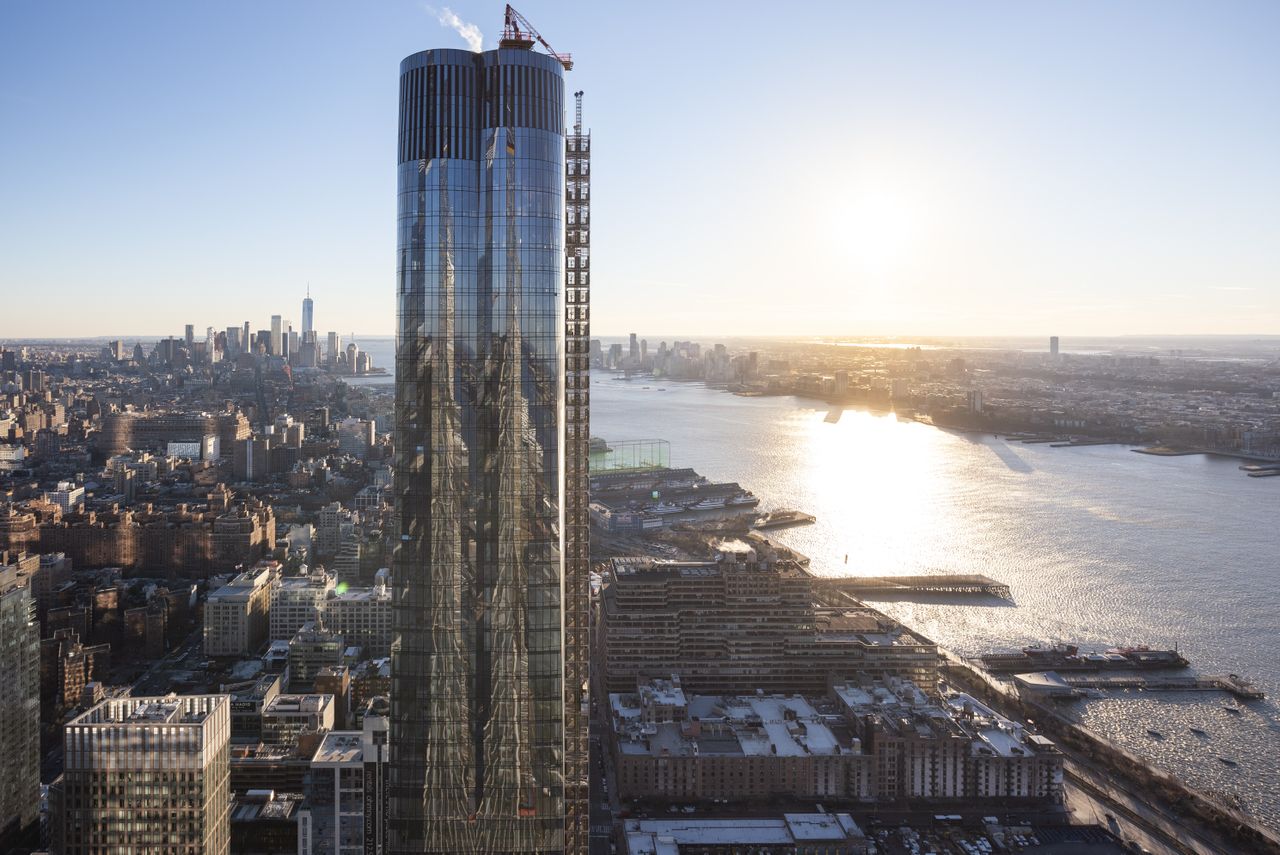 Skyscraper in busy city next to the water