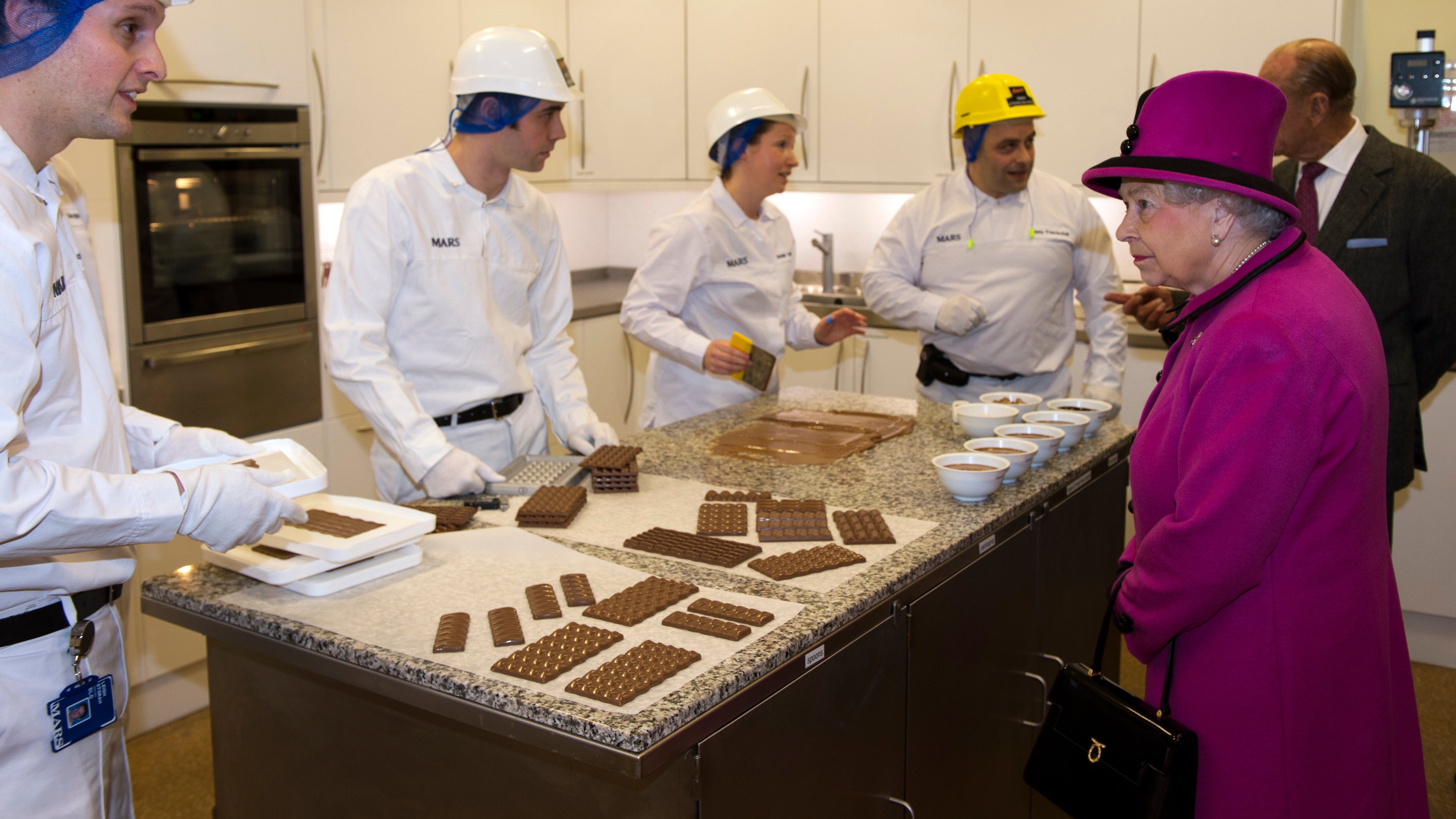 Queen Elizabeth II meets members of staff at the innovation department during a visit to Mars Chocolate UK in Slough,