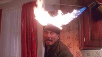Joe Pesci performing the head on fire gag in Home Alone (1990).