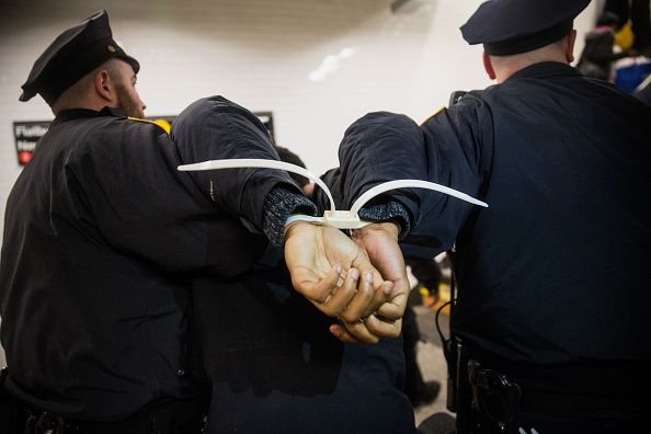 Police arrest a demonstrator.