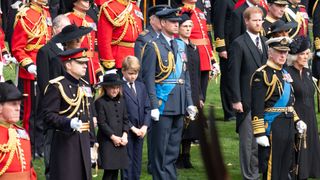 King Charles III, Camilla, Queen Consort, Prince William, Prince of Wales, Catherine, Princess of Wales, Prince George, Princess Charlotte, Prince Harry, Duke of Sussex, Meghan, Duchess of Sussex, Vice Admiral Timothy Laurence, watch as the coffin of the late Queen Elizabeth II arrives at Wellington Arch
