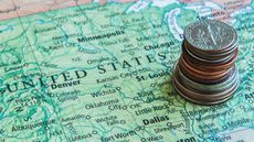 coins stacked on a map of the United States