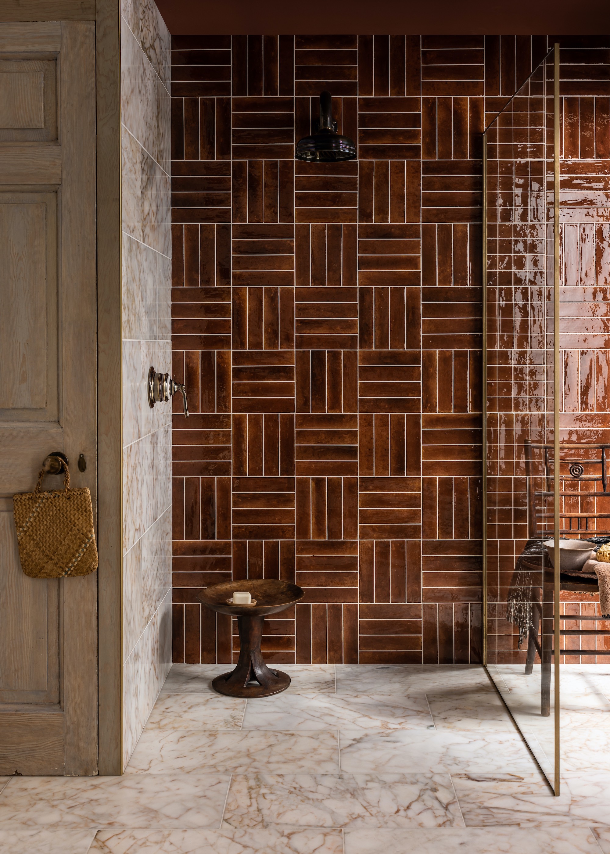 bathroom with zellige tiles and in the corner of the bathroom is a stool