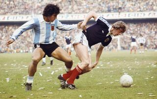 Argentina midfielder Americo Gallego competes for the ball with Scotlands's Kenny Dalglish in a friendly in June 1977.