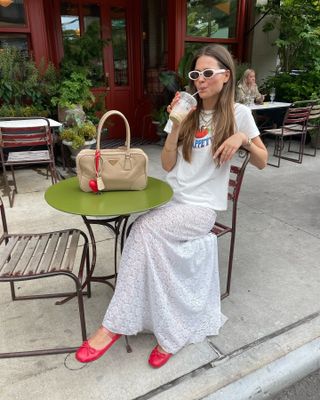 Woman in graphic t-shirt and lace skirt.