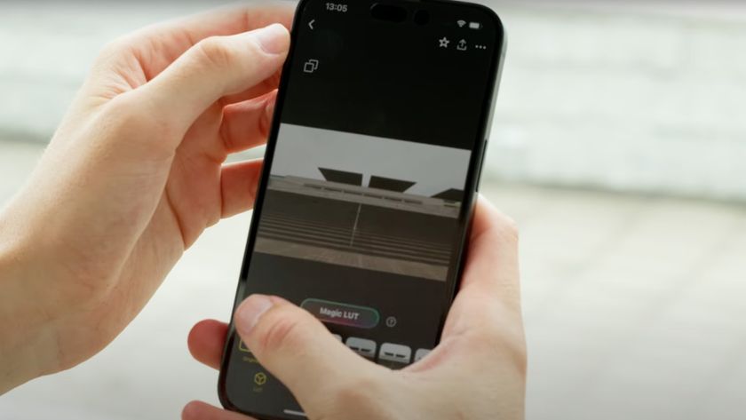 A person holding a smartphone with the Lumix Labs Magic LUTs on the screen
