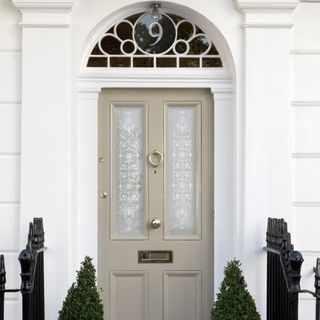 Sage green front door on white house