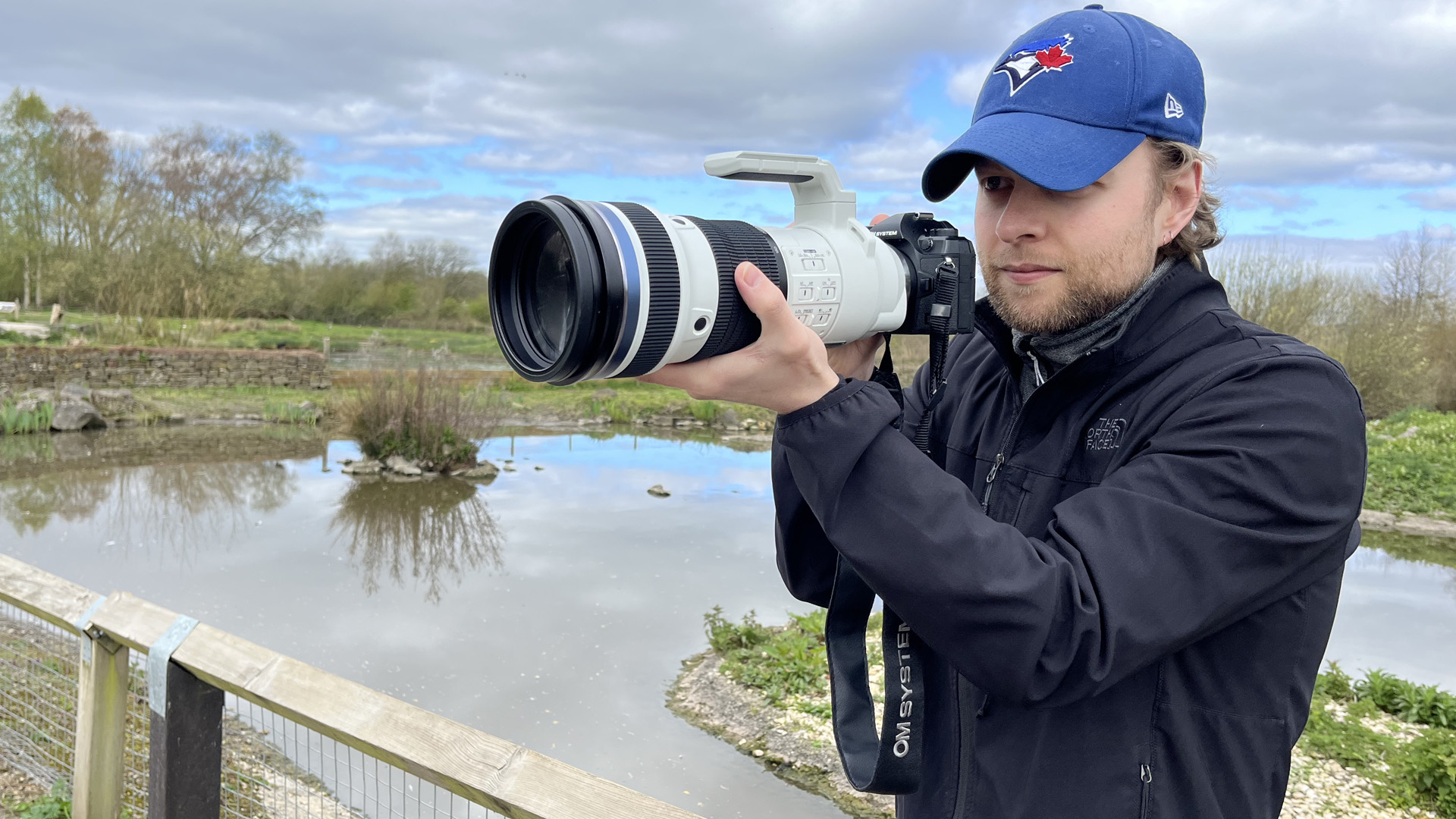 Mike Harris holding OM System M.Zuiko 150-400mm f/4.5 TC1.25x IS PRO at Slimbridge Wetland Centre