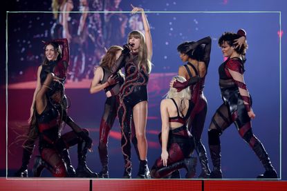 Taylor Swift and backing dancers performing on stage during her Eras tour
