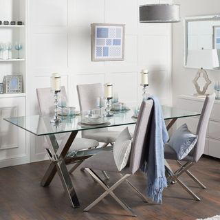white dining room with glass table and chairs