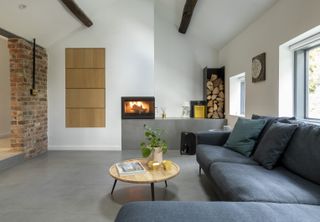 white chimney breast in modern living room with an inbuilt fire