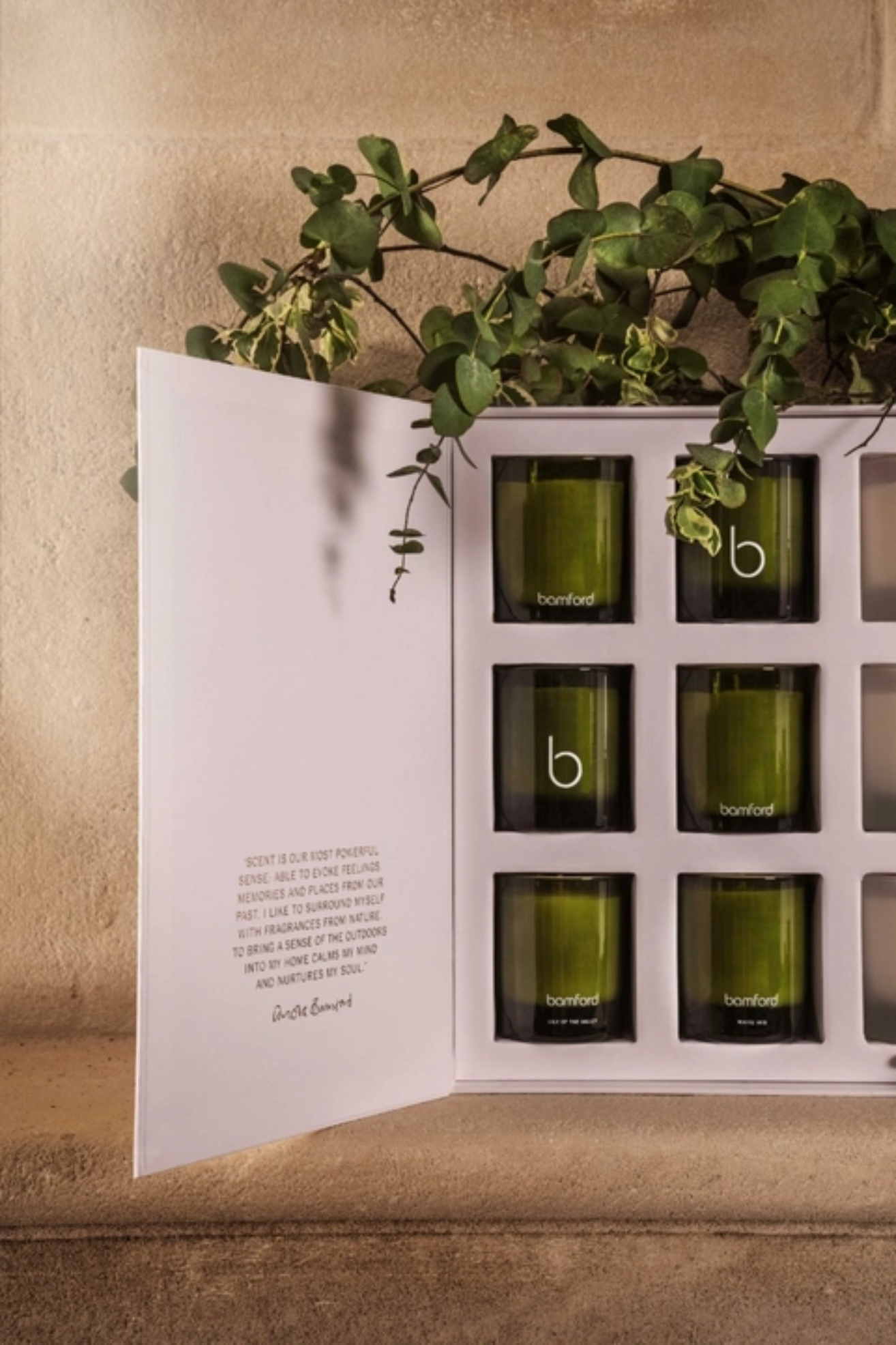 A white advent calendar with green and white glass candles