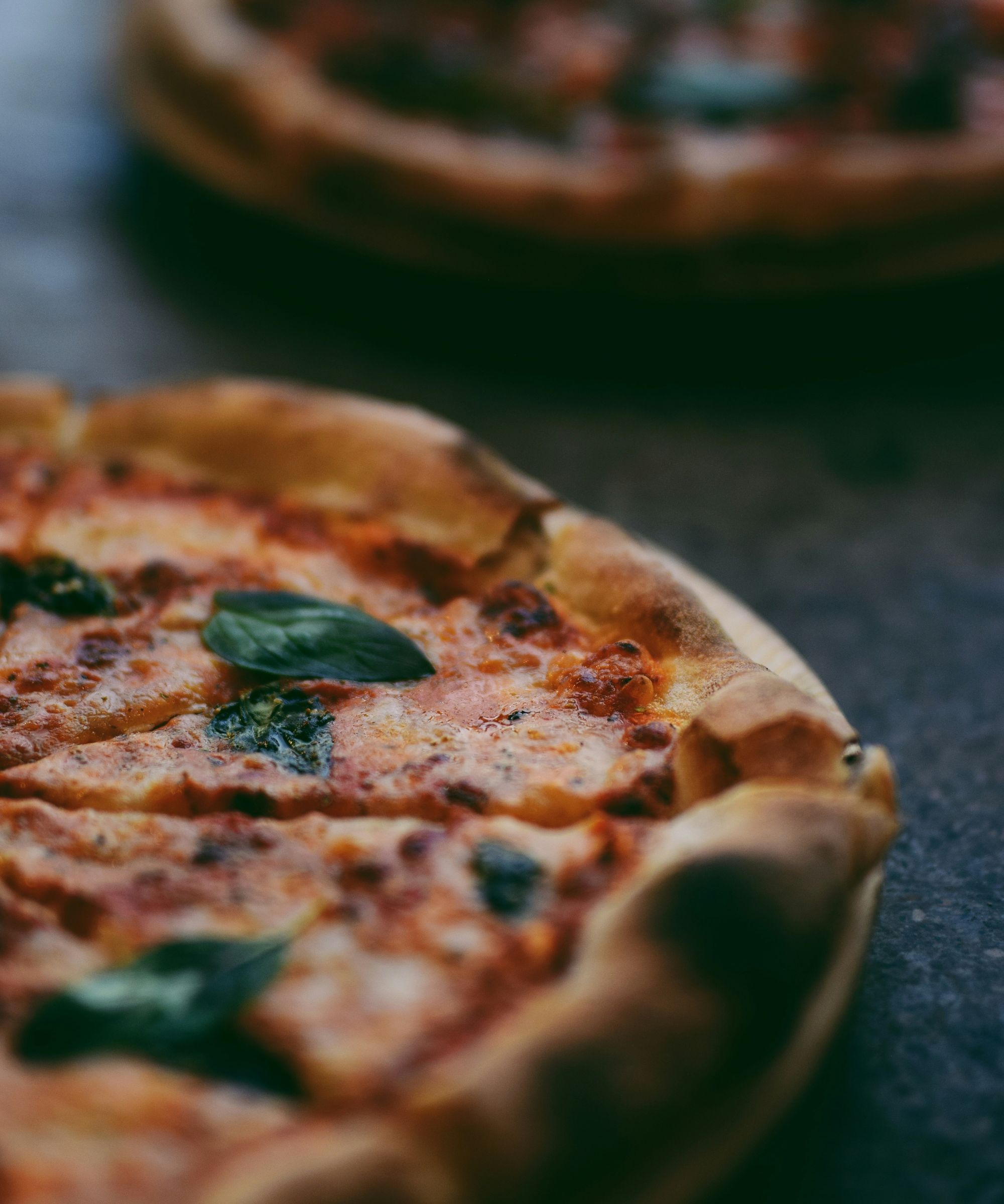 Margherita pizza topped with basil leaves
