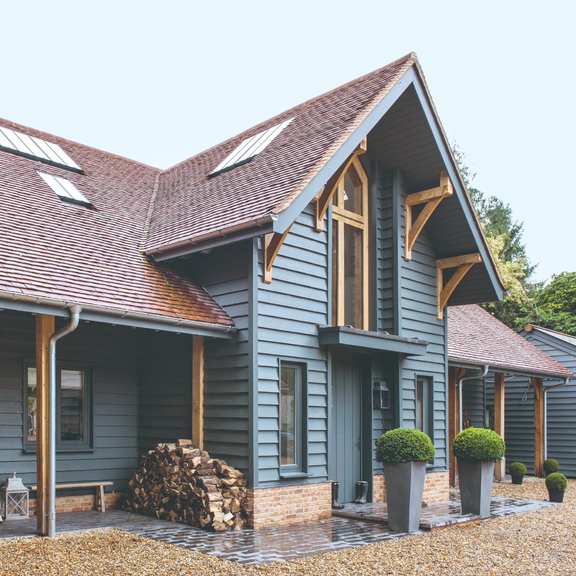 A large two-storey house painted in a blue shade with a grey undertone