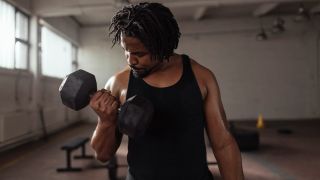 Man performing biceps curls with dumbbells