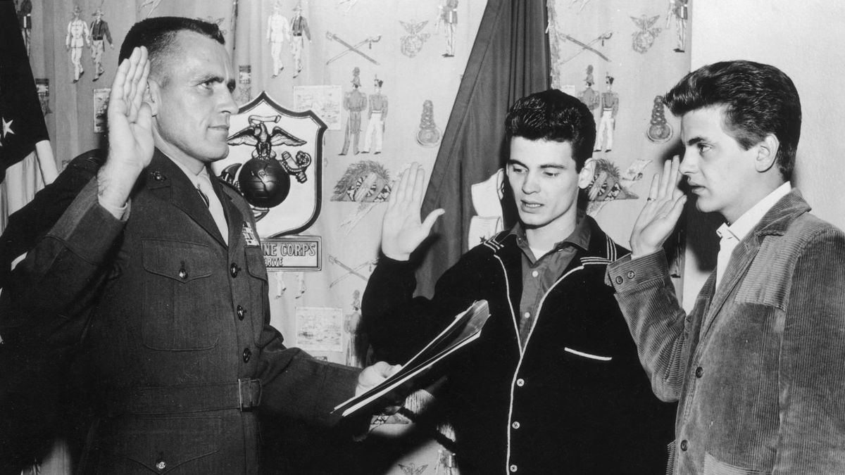 1961: American rock n&#039; roll musicians Don (left) and Phil Everly, the Everly Brothers, raise their hands as they are sworn into the United States Marine Corps by a uniformed officer.