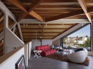 Station Lodge is an unusual London house with a huge gray pitched roof and red stairs