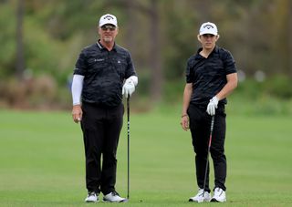 David and Brady Duval stand on the fairway during the PNC Championship