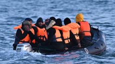 Migrants travel in an inflatable boat across the English Channel, bound for Dover