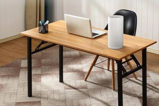Meross Smart Air Purifier on a desk next to a laptop