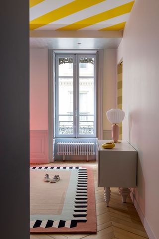 a colorful room with a stripe painted ceiling
