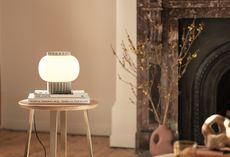 Doric table lamp by Heal's on a wooden table