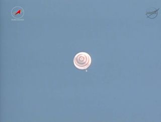 A Russian Soyuz TMA-08M capsule descends to Earth under a parachute during a successful landing on the steppes of Kazakhstan on Sept. 10, 2013 EDT (Sept. 11 local time).
