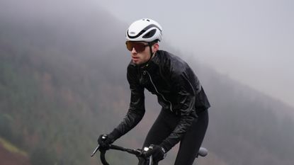 Cycling raincoat with clearance hood