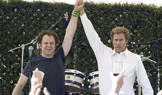 Step Brothers John C. Reilly and Will Ferrell raise their hands in triumph