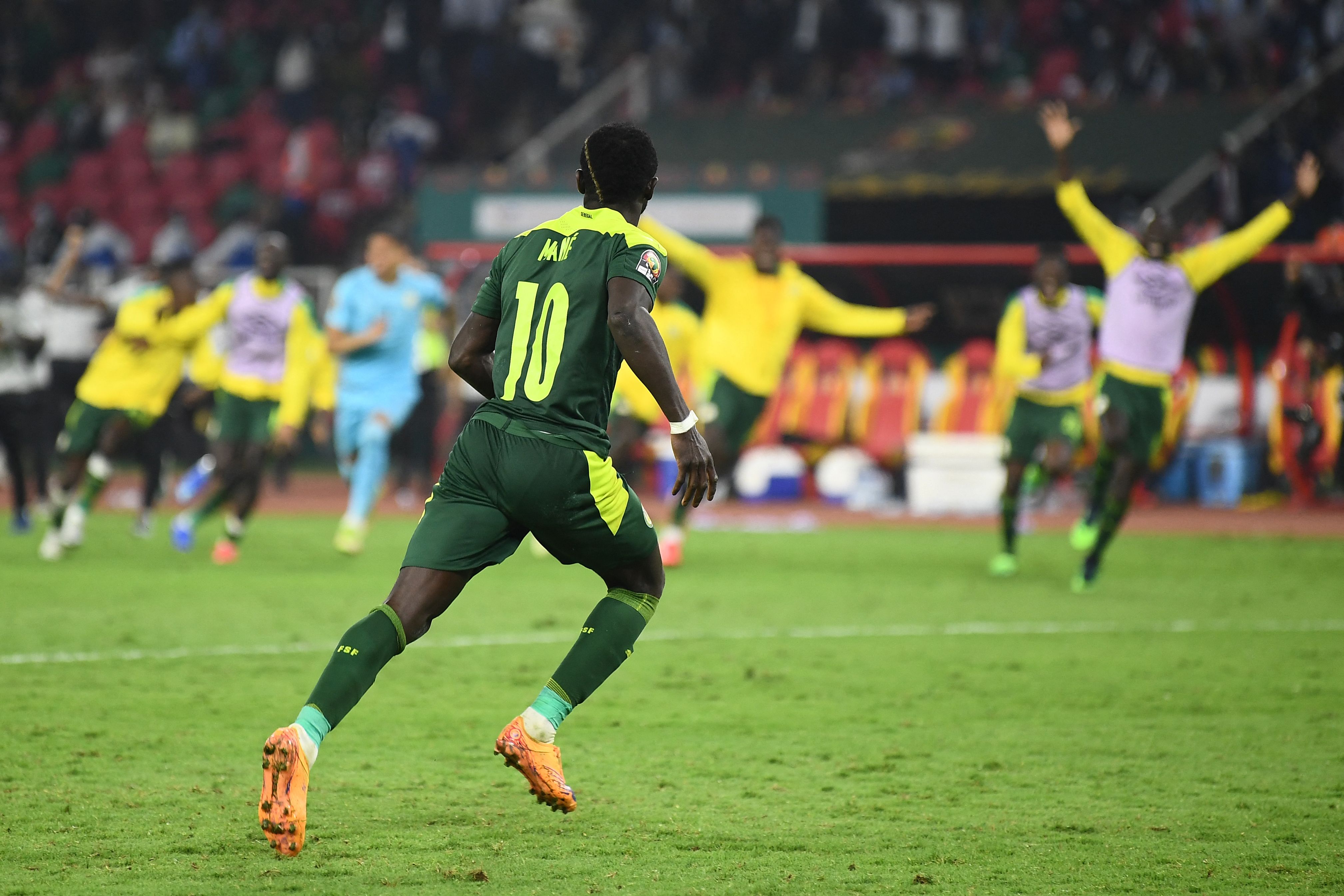 Sadio Mane celebrates after scoring the winning penalty for Senegal against Egypt in the 2021 Africa Cup of Nations final.