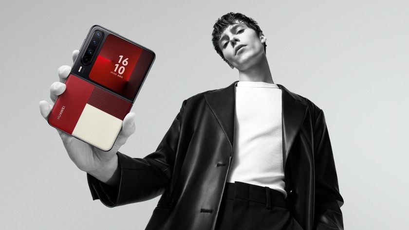 The Huawei Pura X in its stylish red option being held by a model.