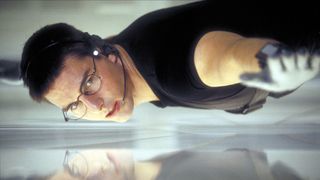 Tom Cruise as Ethan Hunt in Mission: Impossible, hanging above the floor