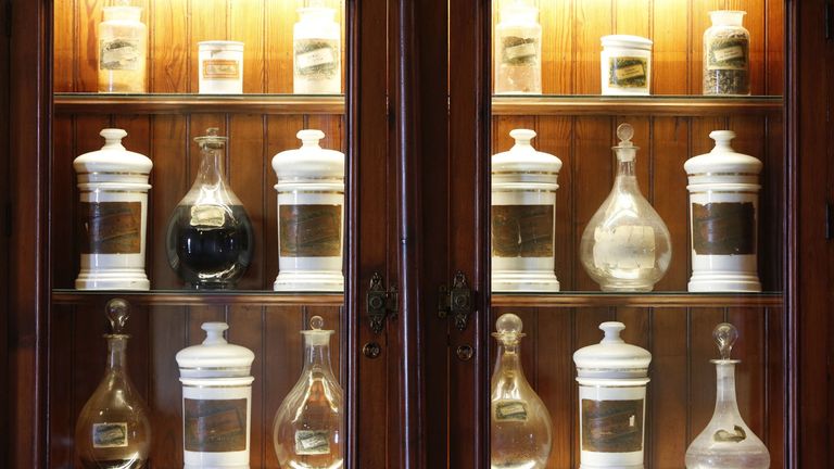 Wooden cabinet encasing glass jars