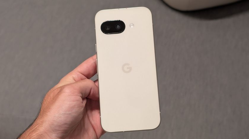 The Porcelain Google Pixel 9a held in hand