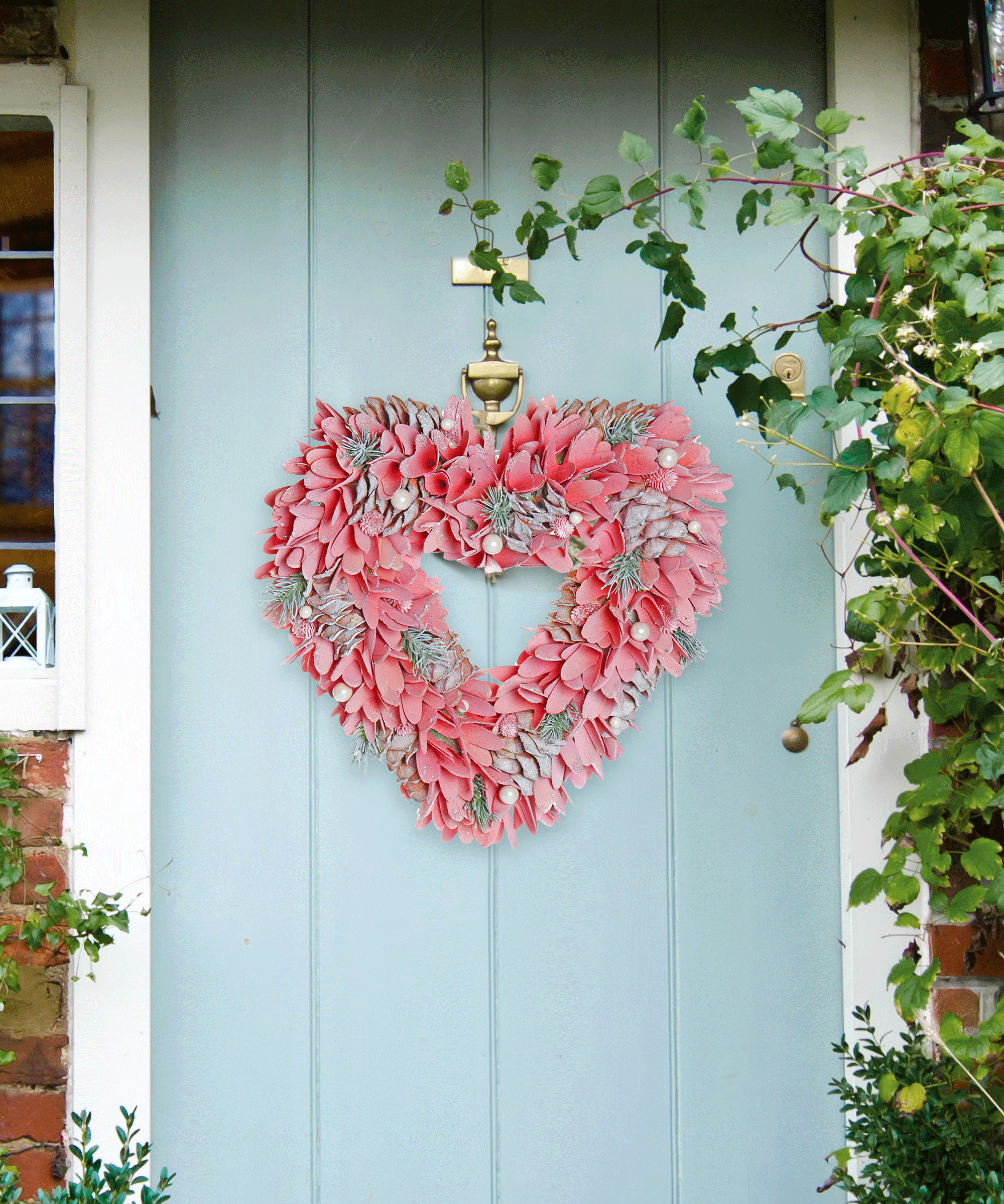 Spring doorscape with soft blue painted front door, and seasonal, pink, heart shaped wreath.