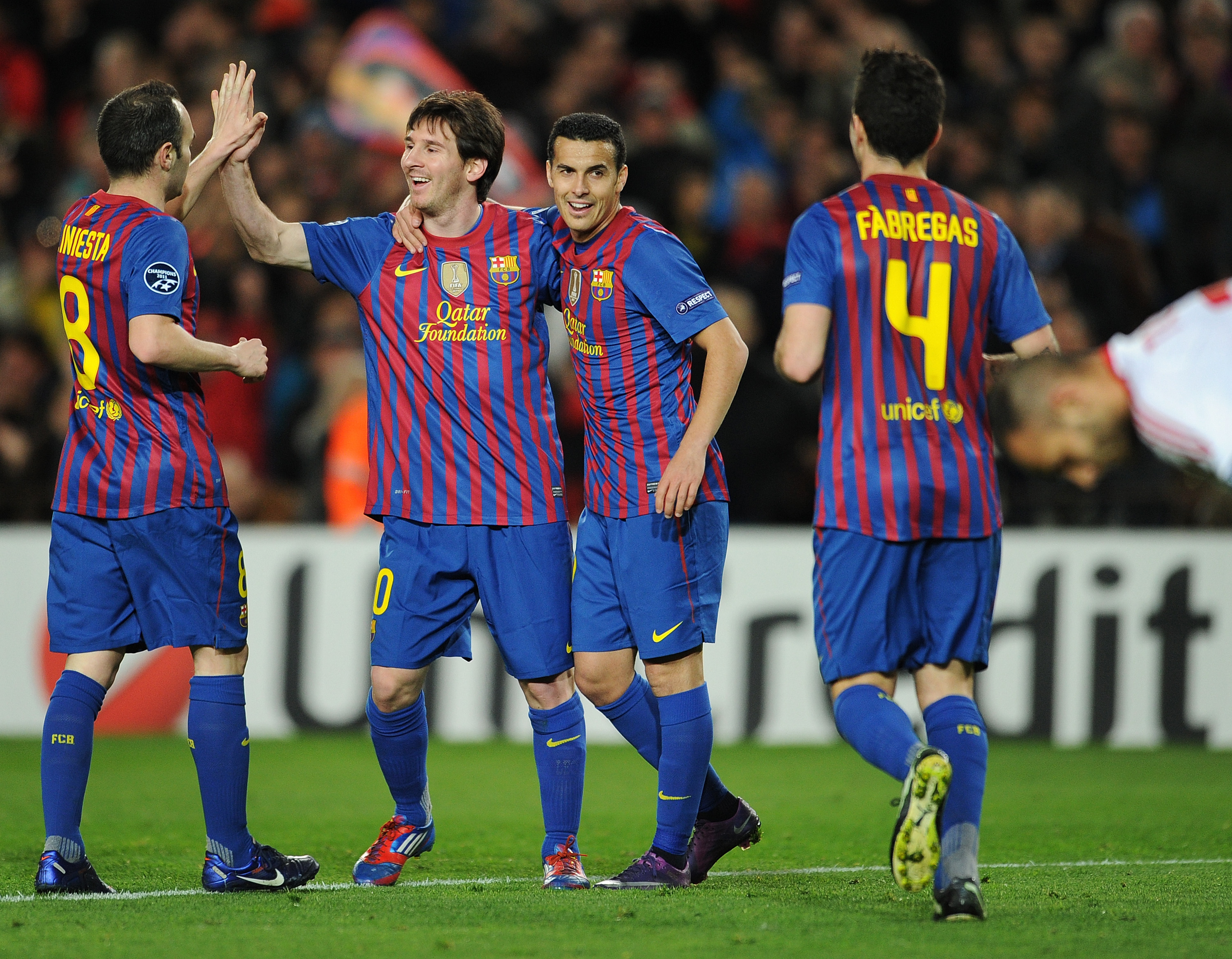 Lionel Messi celebrates with his team-mates after scoring for Barcelona against Bayer Leverkusen in the Champions League in March 2012.