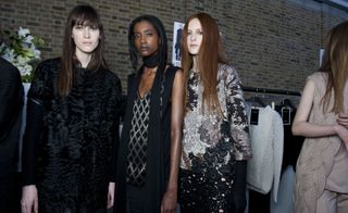 Three female models wearing dark coloured clothing by Pringle of Scotland
