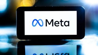 A screen with a stylised M logo and the word Meta sits on a reflective surface