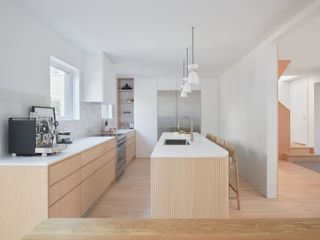 A kitchen with a narrow shelf next to the cabinets