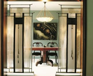 Private residence, Istanbul, Türkiye, 1999. Matching pair of Lilou GrumbachMarquand-style metal screens with Fortuny glass pendant light at the center. ©Koray Erkaya