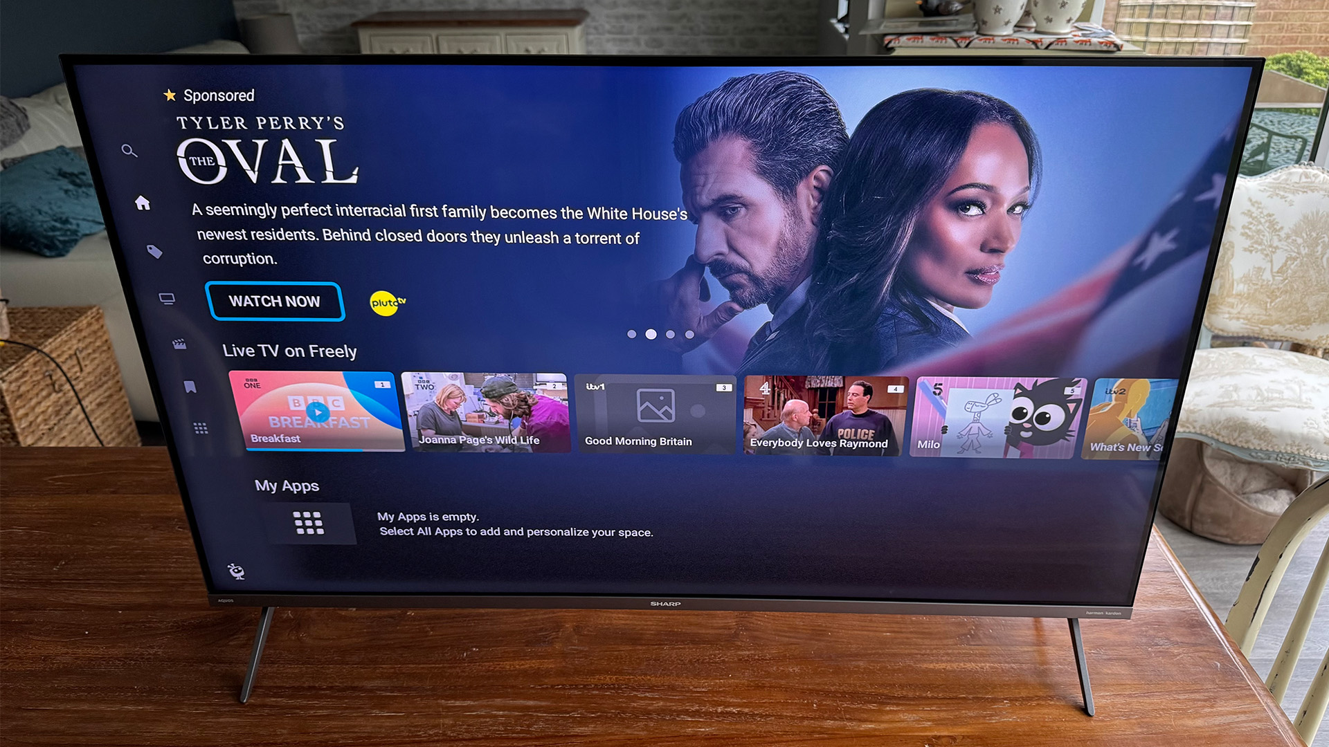 Sharp GM6245K 43-inch TV on wooden table, on screen is Tivo homescreen