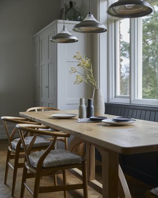 triple pendant light above farmhouse dining table
