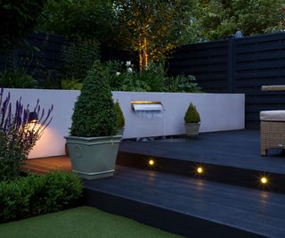 deck and steps with lighting, plants and water wall