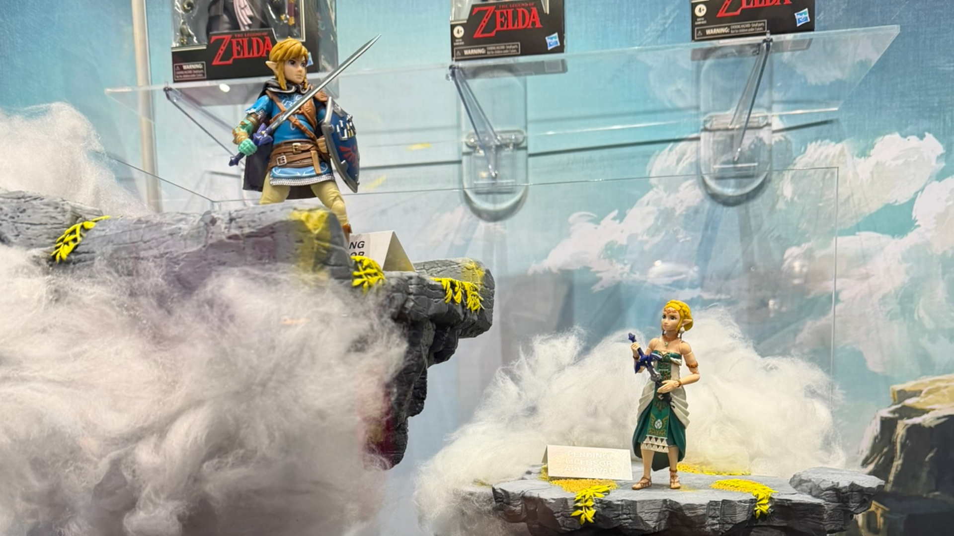 Link and Princess Zelda action figures posed on sky islands against a cloudy background