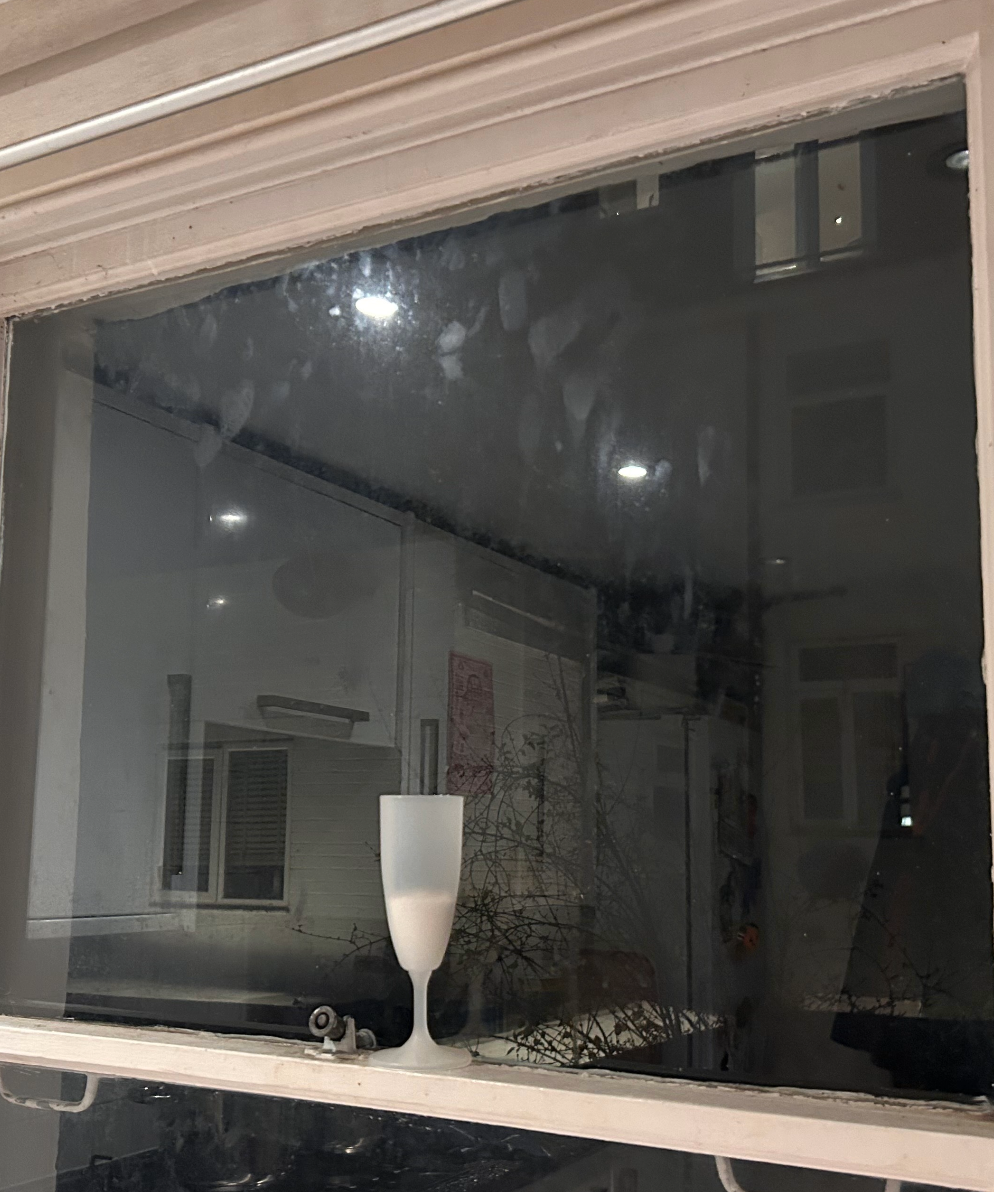 Glass of salt on a window sill