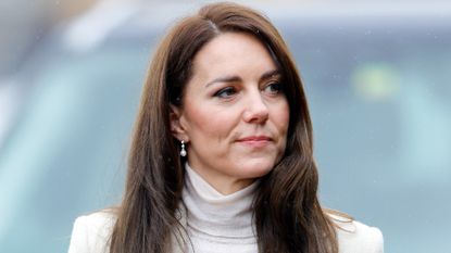 Kate Middleton tersely smiles at an engagement