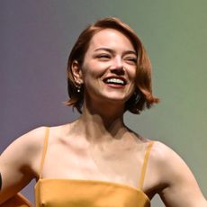 Emma Stone wearing Louis Vuitton custom gown in Showgirl Orange