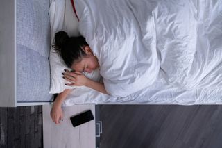 A woman overheats while sleeping in bed